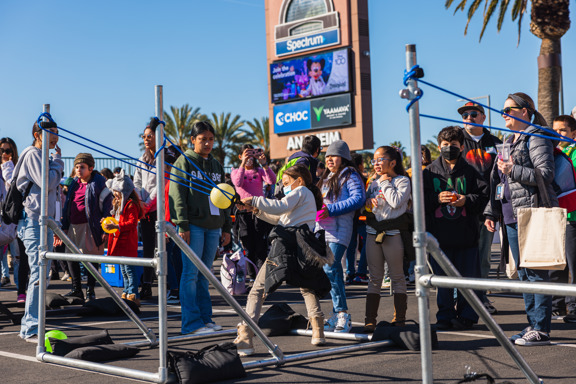Students pull back large sling shot