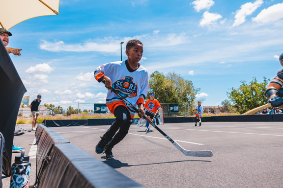 Street hockey player in running stride