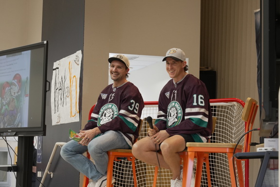 Ducks players on stage laughing