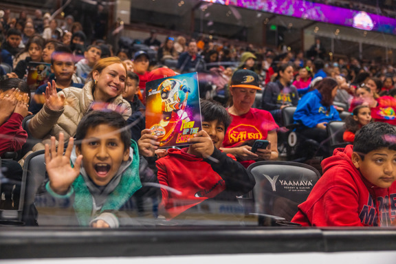 Students sit in Honda Center at First Flight