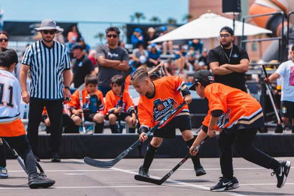 Street hockey players at face off