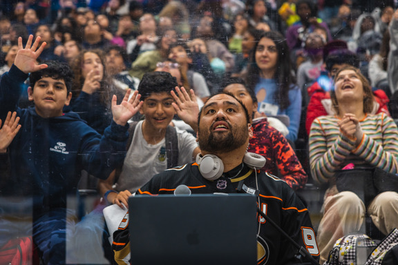 DJ Jojo looks up at students in Honda Center